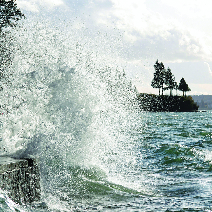 The walkway on Vancouver's sea wall is submerged by waves.