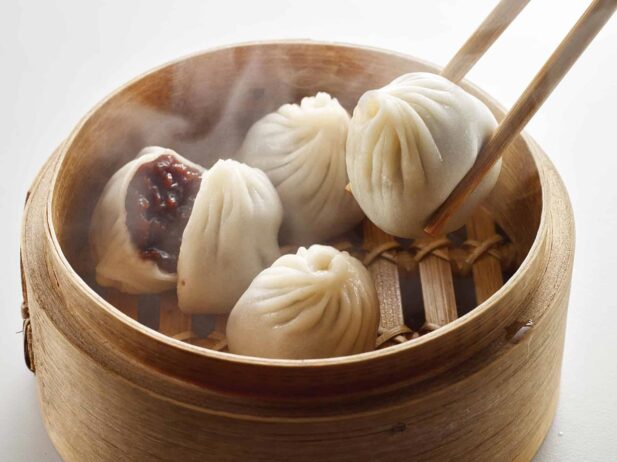 A bamboo steamer filled with dumplings.