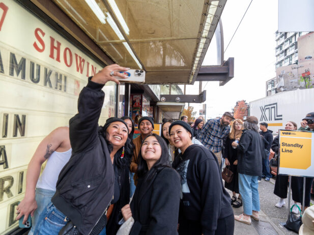 Group of people taking a selfie infront of a theatre