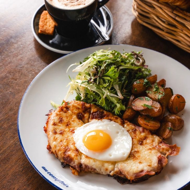 Cheesy toast with a sunny side up egg, salad and potatoes