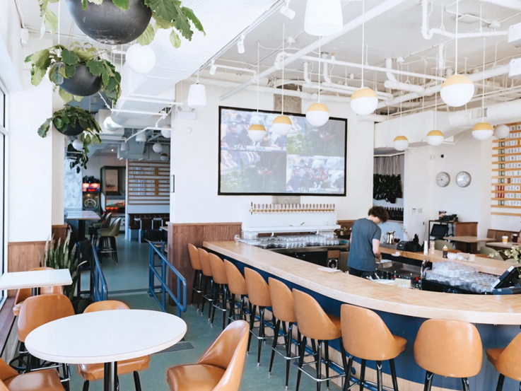 a bright, clean empty bar with leather stools