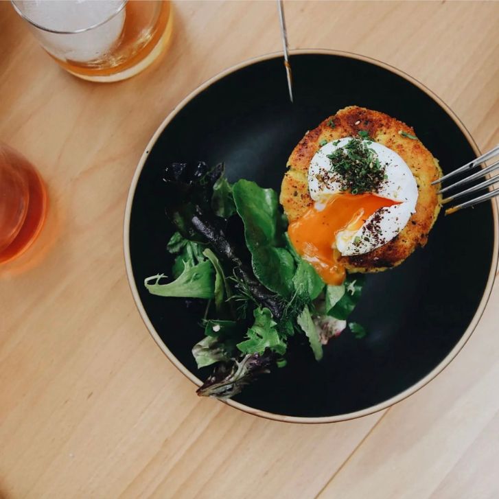 kookoo sibzamini: crispy potato pancakes topped with a poached egg