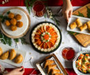 A table filled with fish-based appetizers and dishes on plates.