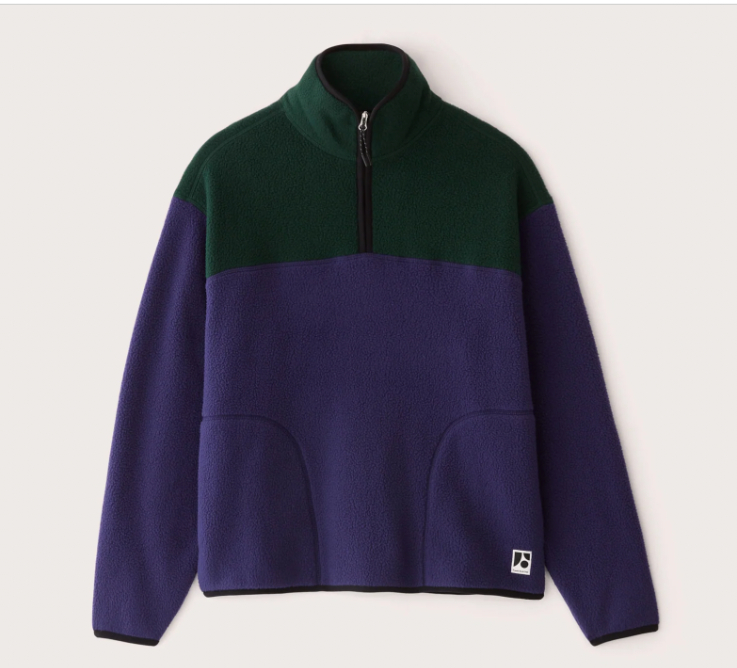 a green and blue half zip sweater, laid flat on a white background