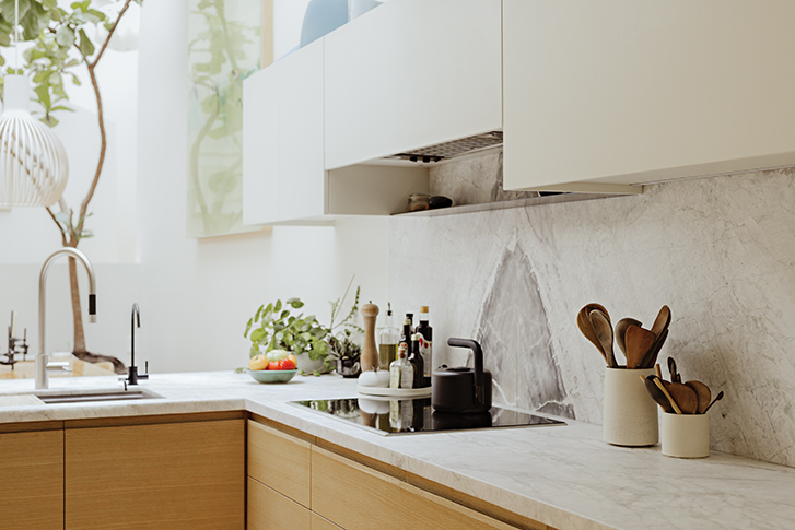 the marble countertops and backsplash of a beautiful kitchen