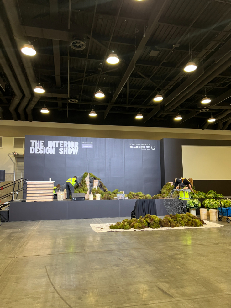 workers setting up a display on a stage