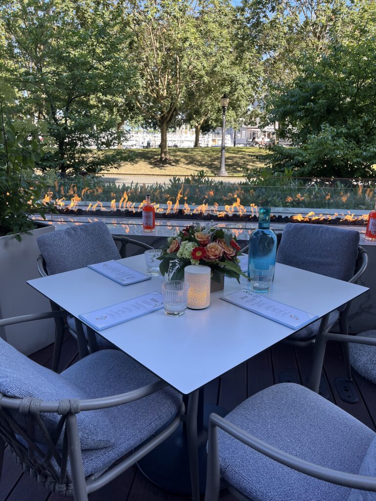 A beautifully set table on a patio overlooking trees.