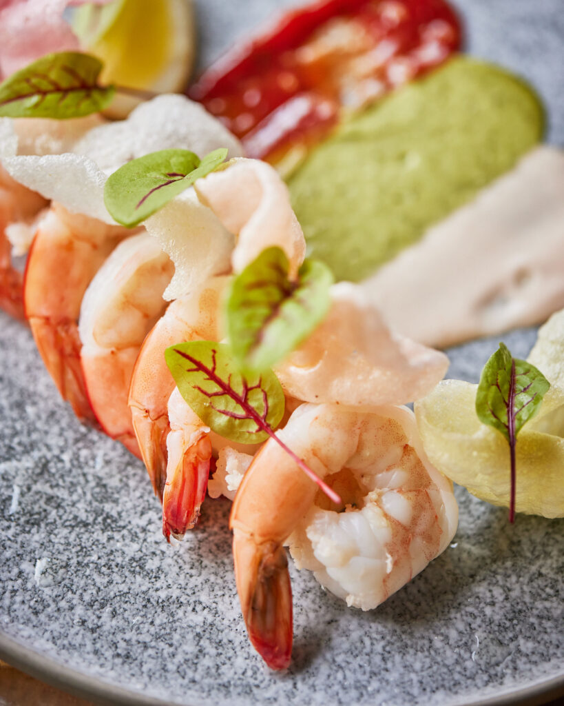 Champagne poached prawns plated with colourful sauces at JW Marriott Parq Vancouver’s LePicnic rooftop event