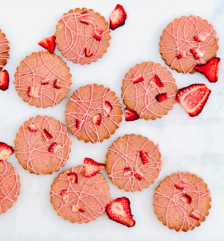 Pink cookies and sliced strawberries