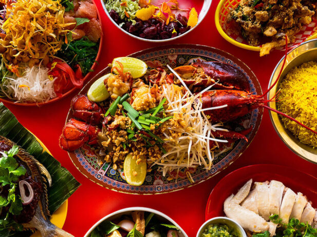 8 Southeast Asian dishes with a lobster in the middle.
