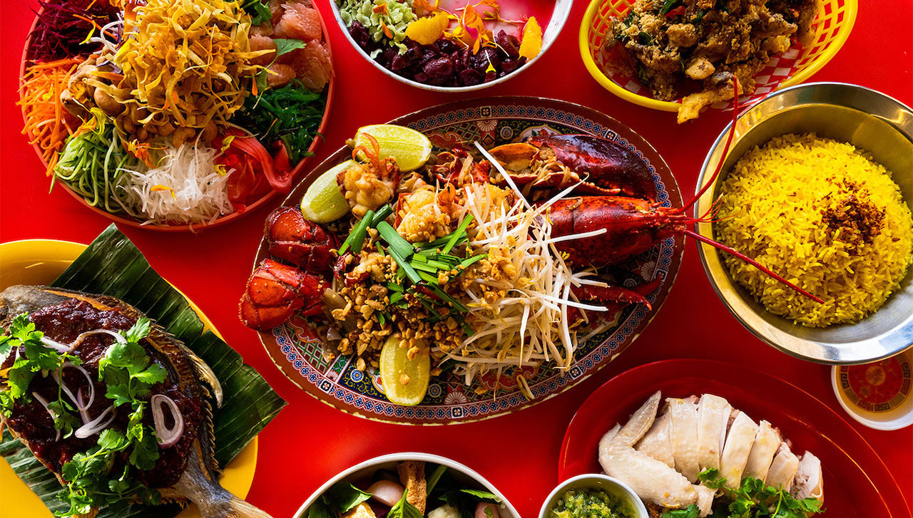 8 Southeast Asian dishes with a lobster in the middle.