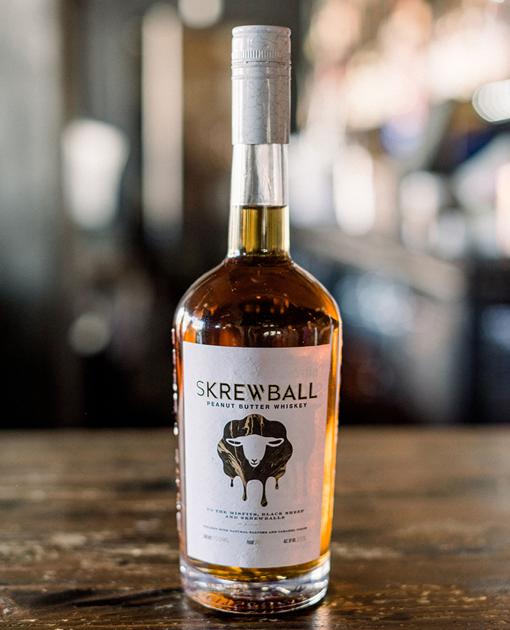 A bottle of Skrewball peanut butter whisky on a bar