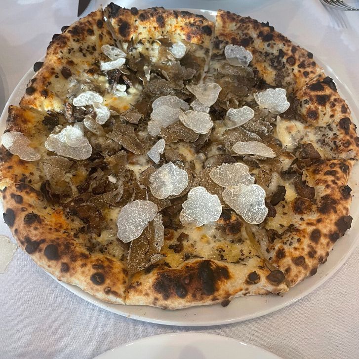 Close up of a truffle pizza with white truffle topping