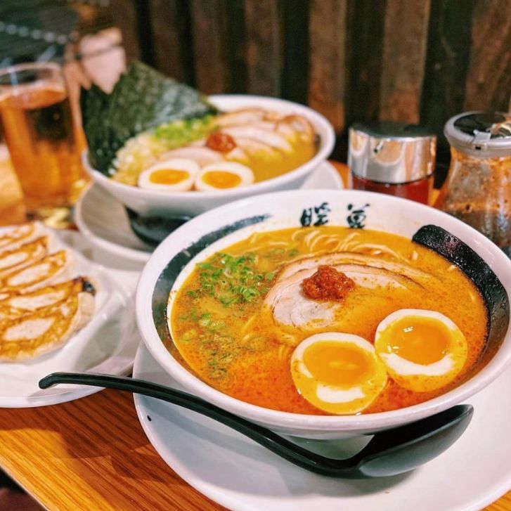 Two bowls of tonkotsu ramen topped with chashu and soft boiled eggs. 