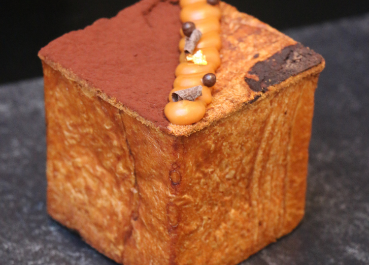 Dessert cube with chocolate on top. 