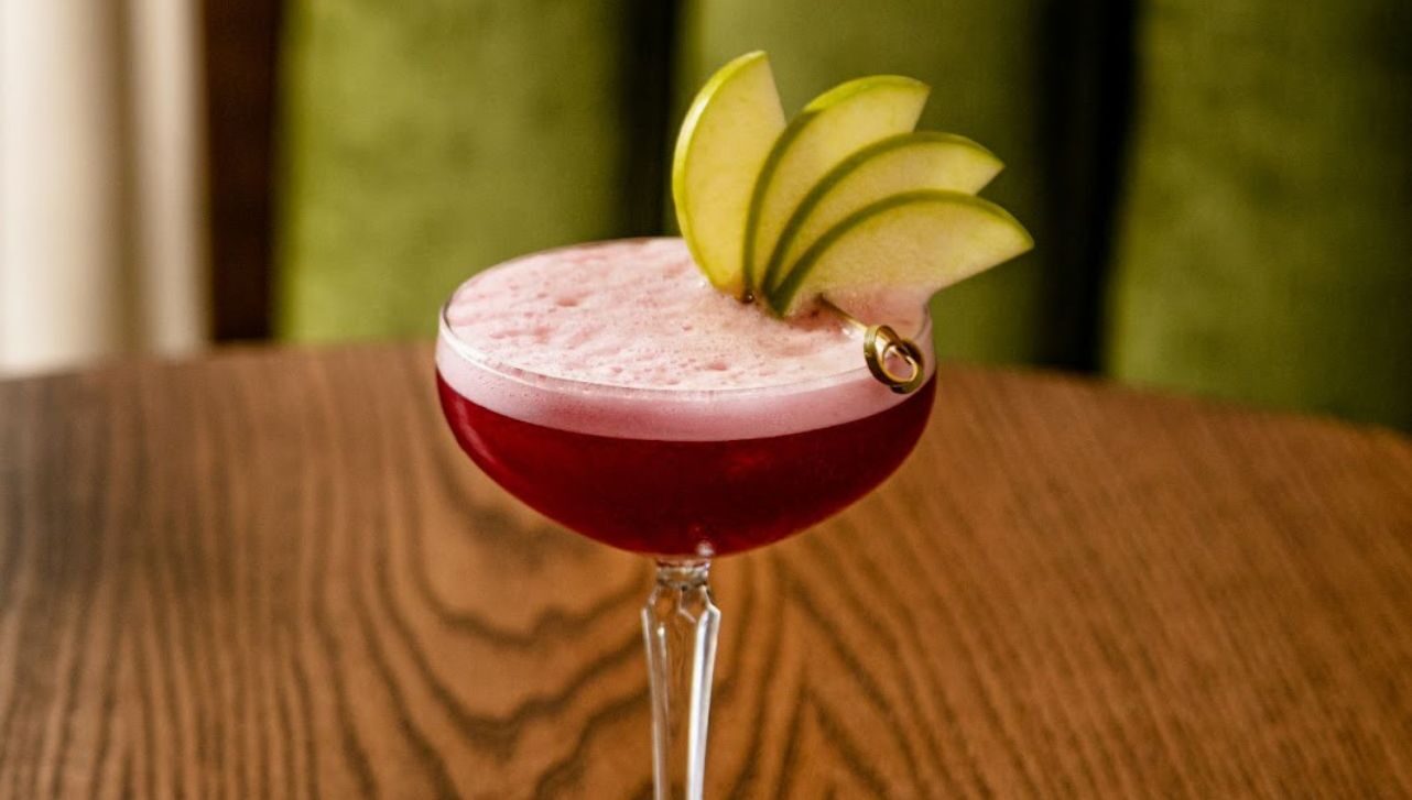 Close up of a red cocktail with pear