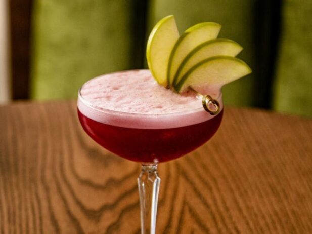 Close up of a red cocktail with pear