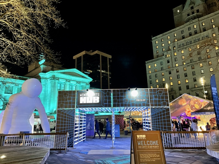 Outside of the festival entrance with lights and an inflatable statue