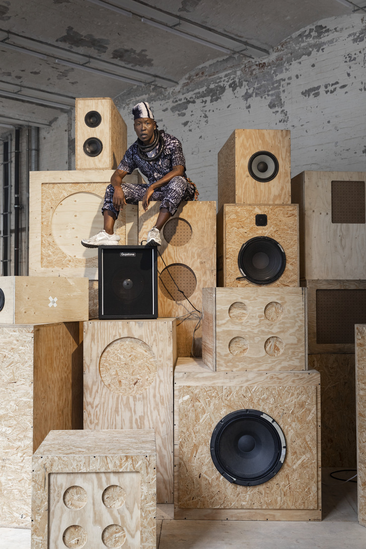 Afternow promo of performer sitting on speakers