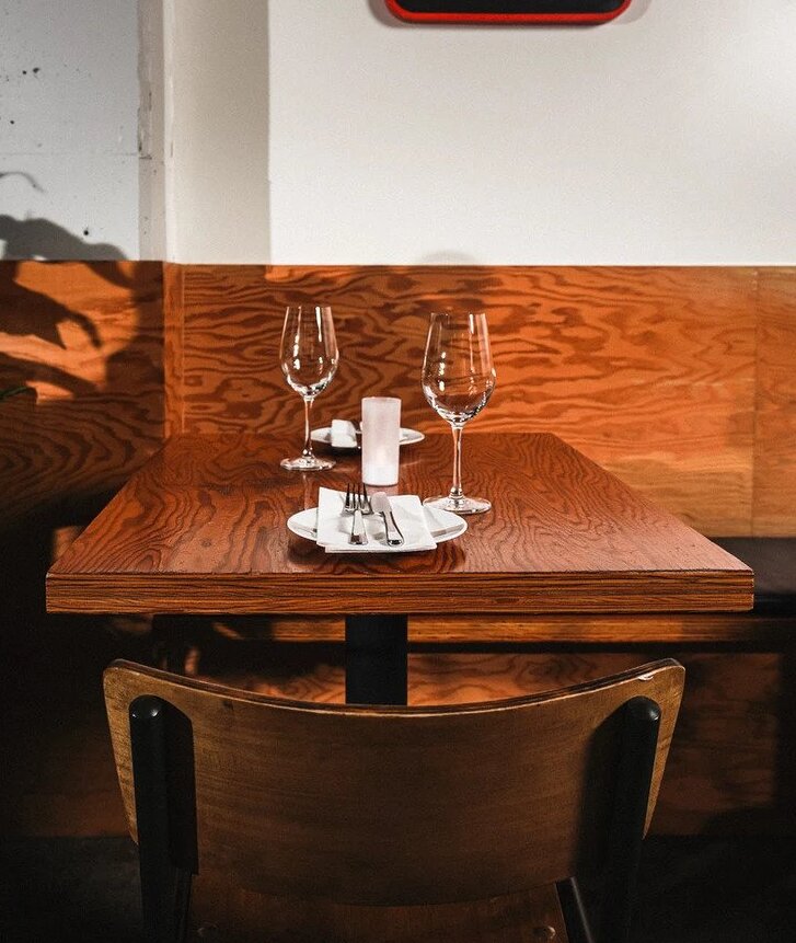 Empty wooden table with wine glasses