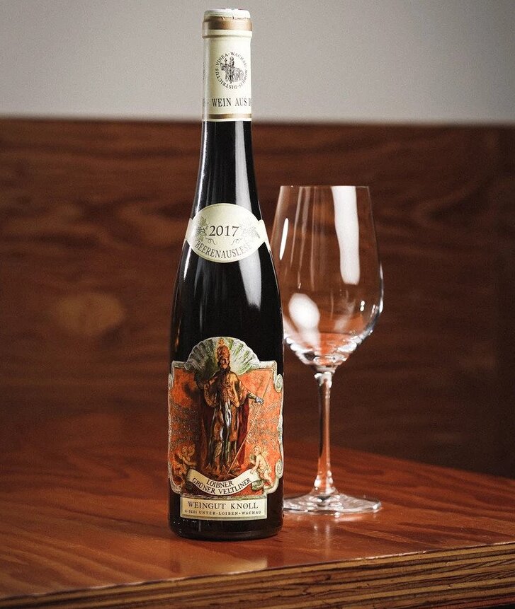 wine bottle and glass on wooden table