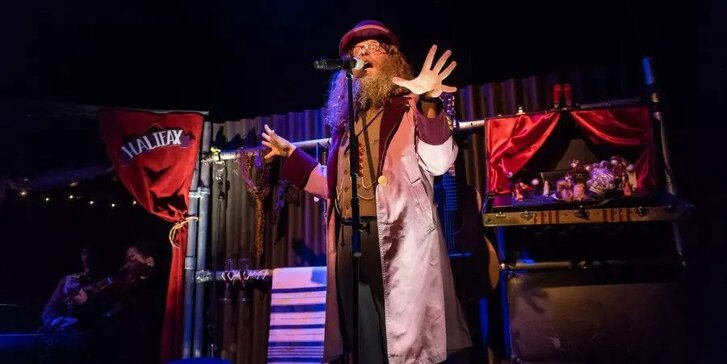 Bearded man presenting on a stage