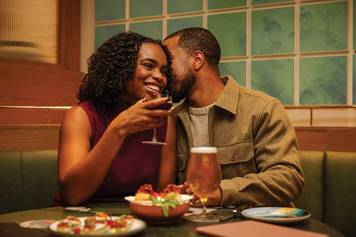 A couple enjoying a meal at Louiza