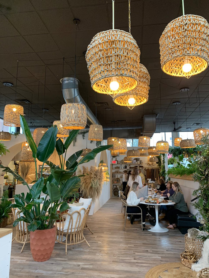 Revive Boutique Bistro with wicker lights and houseplants