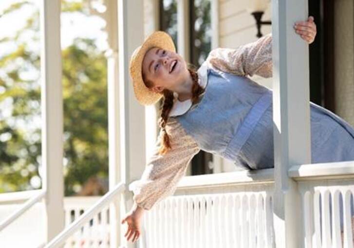 The image of Anne of Green Gables on a porch
