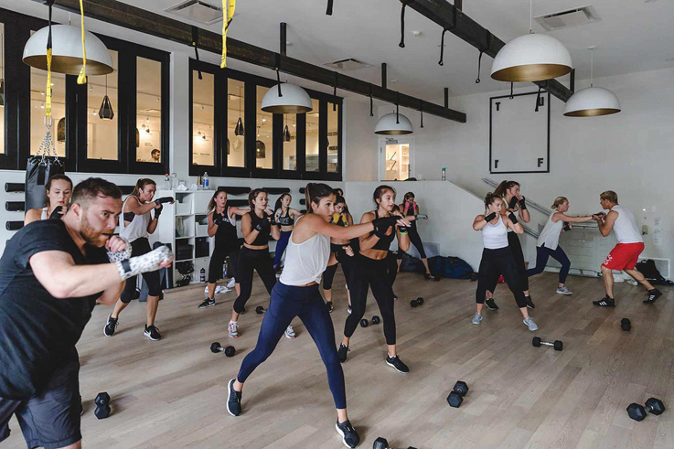 a room full of people air-boxing