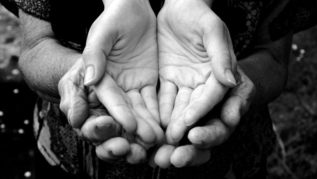 Young hands nestled in old hands.